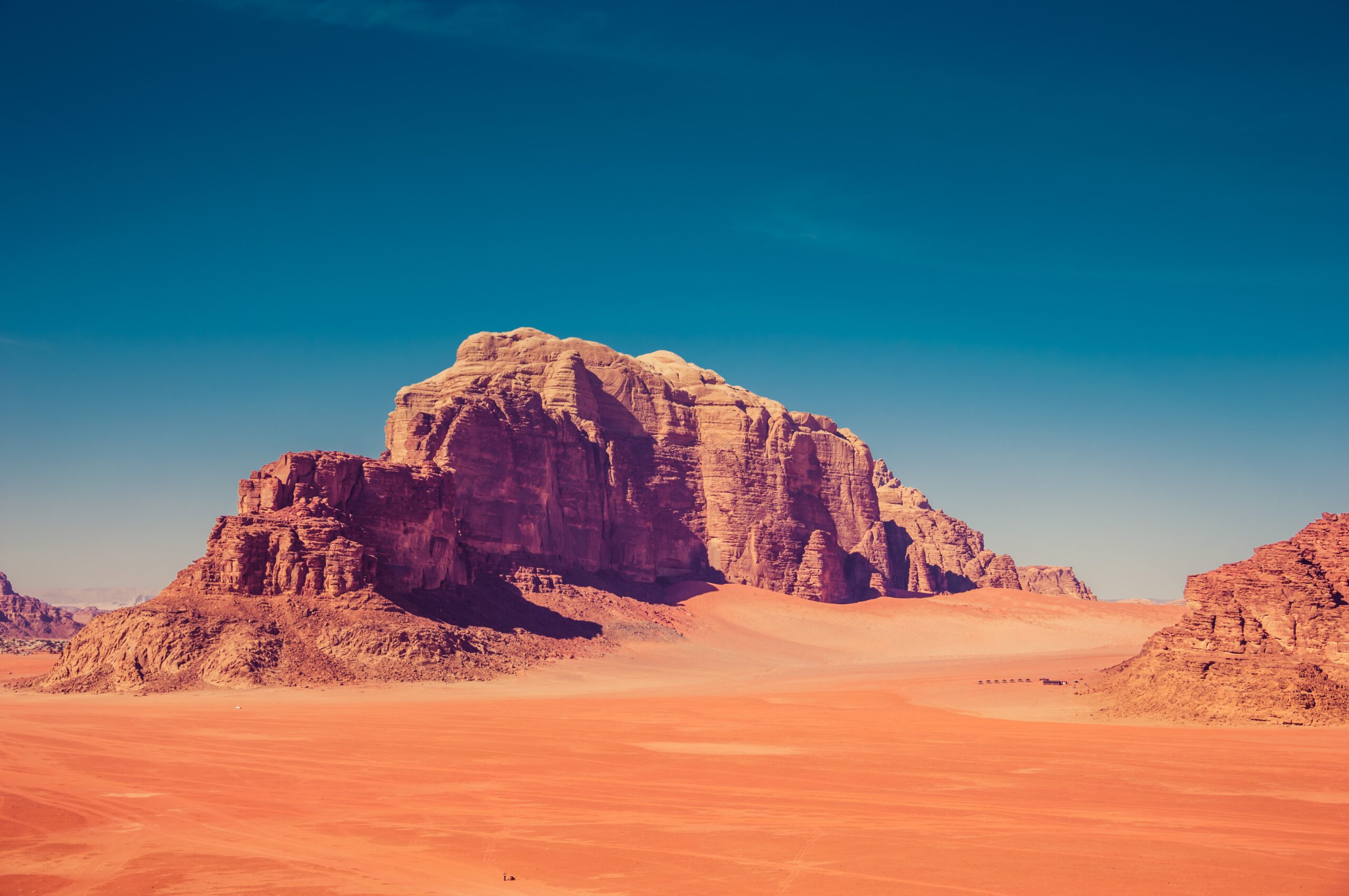 Brown Rock Formation Surrounded By Sand Dunes Scaled Brown Rock Formation Surrounded By Sand Dunes